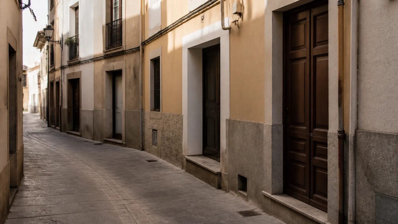Old-centre street in Sant Boi de Llobregat with plaster façades and building portals